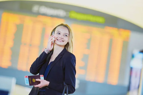 Junge Geschäftsfrau auf internationalem Flughafen — Stockfoto