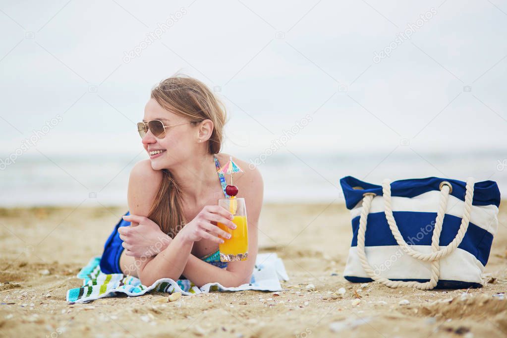 Woman relaxing and sunbathing on beach