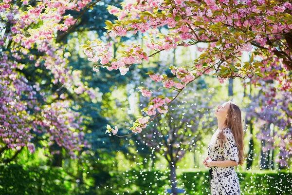 Vacker ung kvinna i blommande våren park — Stockfoto