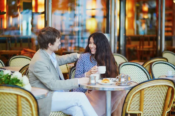 Casal beber café e comer croissants no café parisiense — Fotografia de Stock