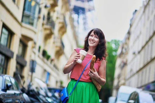 French woman walking with coffee to go and baguette on a street of Paris — Stock Photo, Image