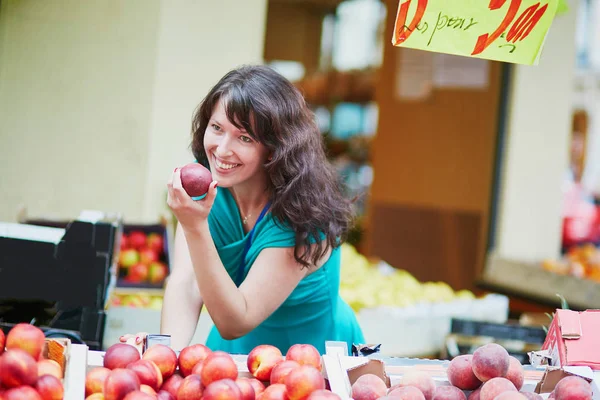 Fransk kvinna att välja frukter på marknaden — Stockfoto