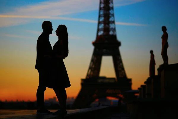 Sylwetki romantyczna para w pobliżu wieży Eiffla, o wschodzie słońca — Zdjęcie stockowe