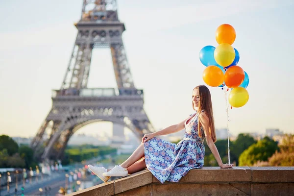 Young woman with bunch of balloons near the Eiffel tower — Stock Photo, Image