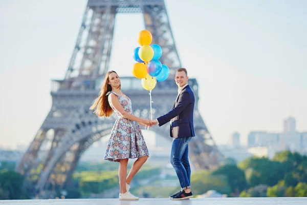 Paar mit bunten Luftballons am Eiffelturm — Stockfoto