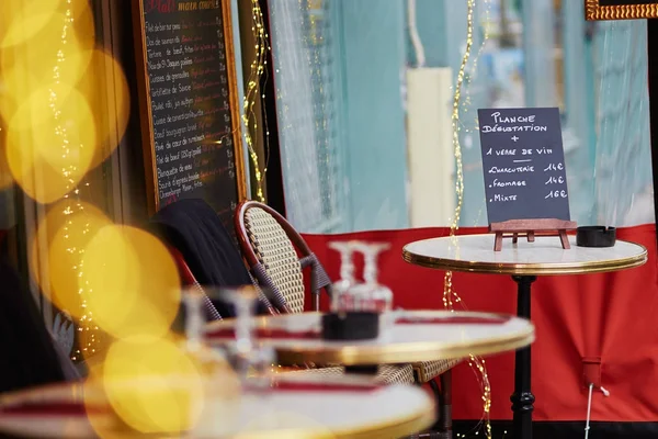 Parisian outdoor cafe with menu board on the table — Stock Photo, Image