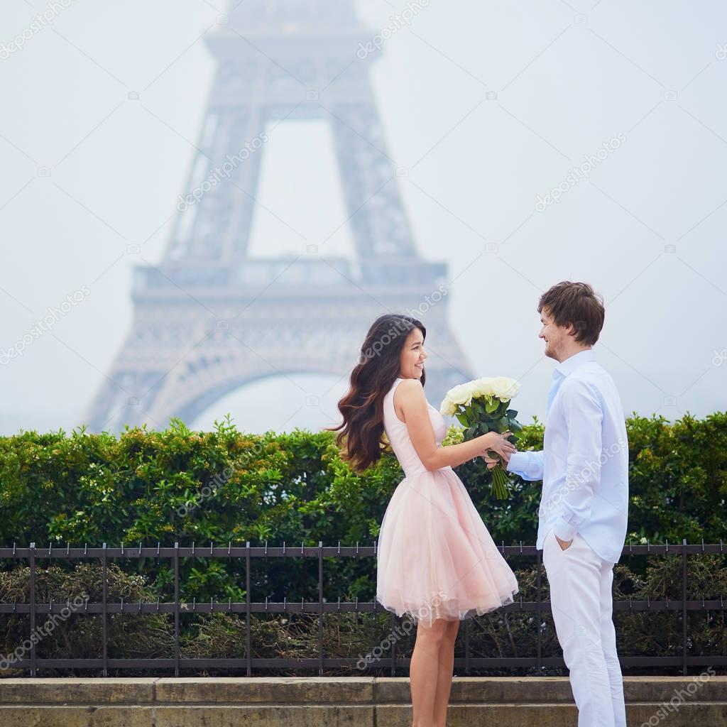 Happy couple near the Eiffel tower