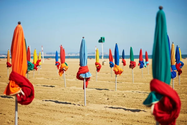 Many colorful umbrellas on the beach of Deauville — Stock Photo, Image