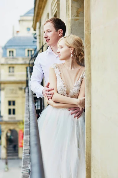Bride and groom on their wedding day on the balcony — Stock Photo, Image