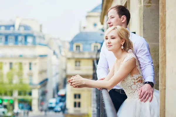 Bride and groom on their wedding day on the balcony — Stock Photo, Image