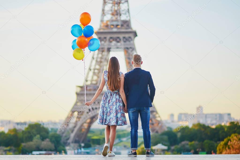 Couple with colorful balloons near the Eiffel tower