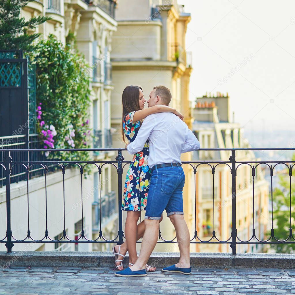 Romantic couple together in Paris kissing each other on Montmartre