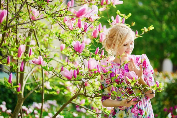 春の日に咲くモクレンの下で若い美しい女性 — ストック写真