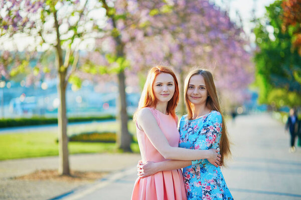 Two beautiful girls together in Paris on a spring day
