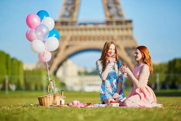 Dos mujeres jóvenes haciendo picnic cerca de la Torre Eiffel en París, Francia —  Fotos de Stock