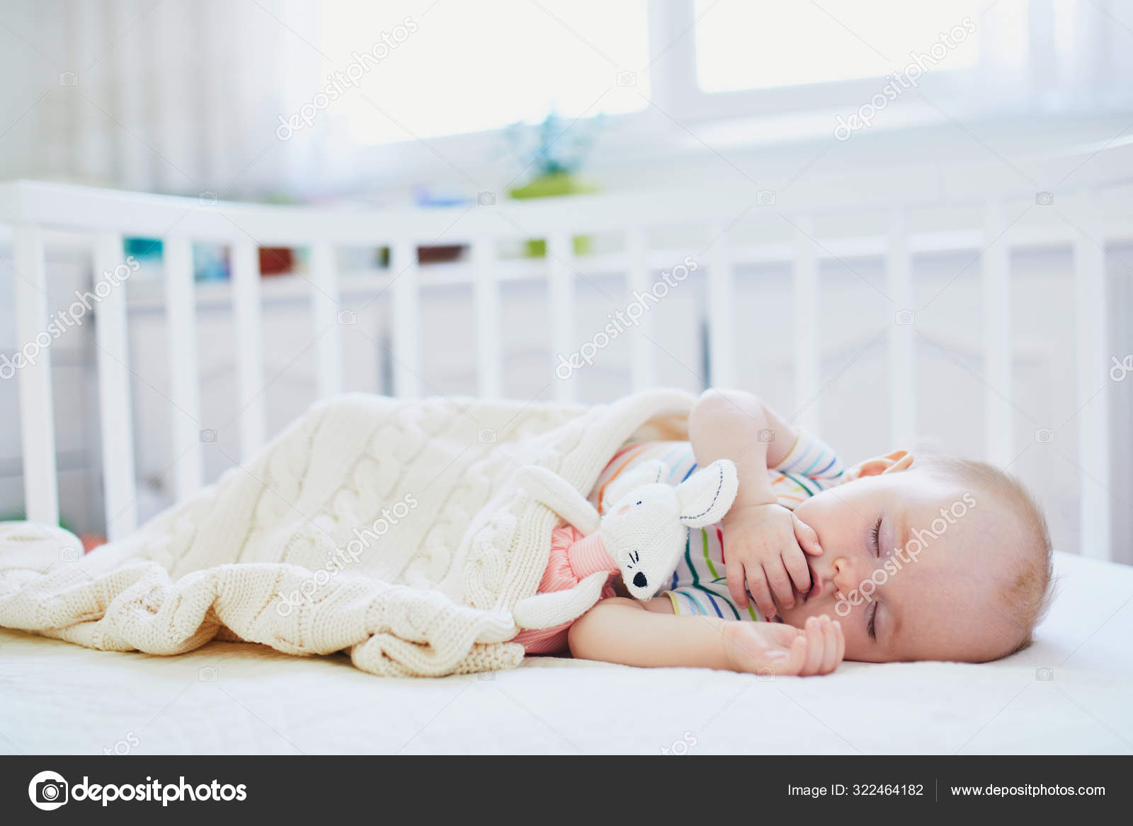baby sleeper in bed with parents