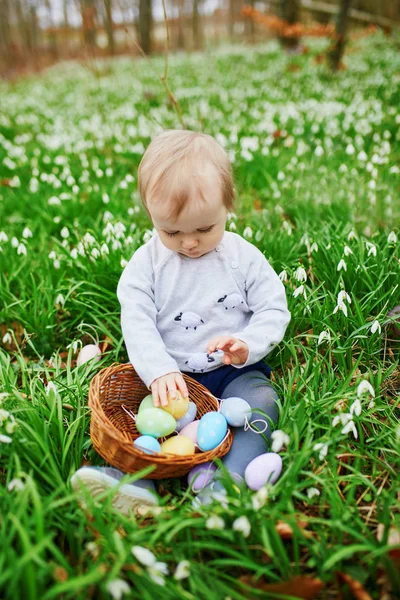 Linda niña de un año jugando a la caza de huevos en Pascua —  Fotos de Stock