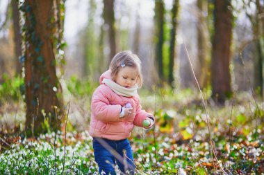 Cute little girl playing egg hunt on Easter