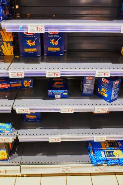 PARIS, FRANCE - FEBRUARY 29, 2020: Half empty shelves at Parisian supermarket during outbreak of coronavirus in 2020