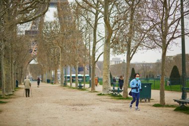 PARIS, FRANCE - MARCH 17, 2020: First day of quarantine in France during outbreak of coronavirus COVID-19. People in Paris practicing physical exercises