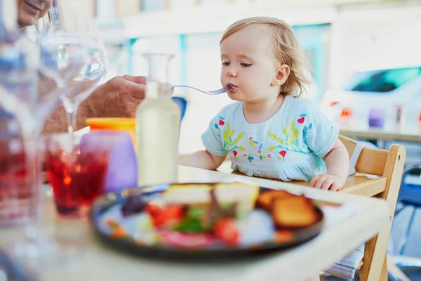 Adorable Toddler Girl Sitting High Chair Cafe Restaurant Father Feeding — Stock Photo, Image