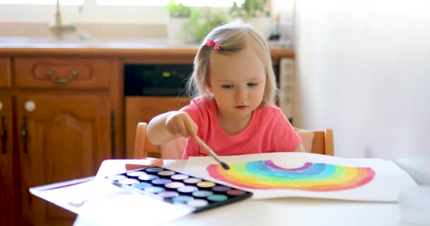 Adorable Little Girl Drawing Rainbow Colorful Aquarelle Paints Home Kindergaten — Stock Video