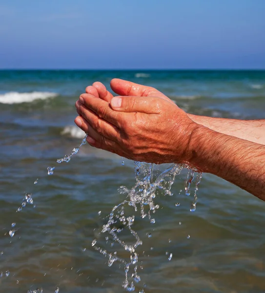 Hands with sea water. — Stock Photo, Image