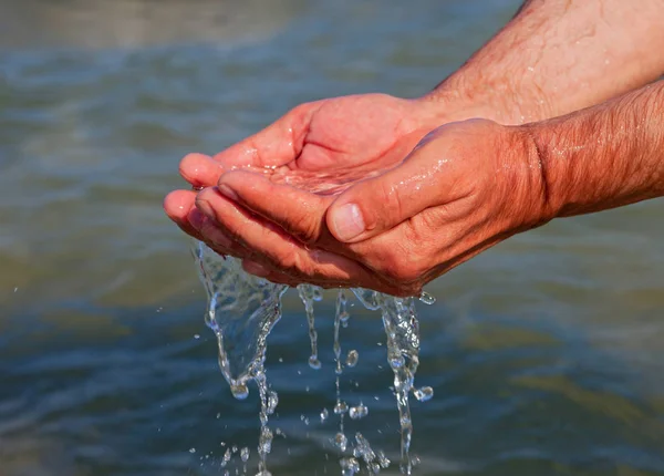 Manos con agua de mar . — Foto de Stock