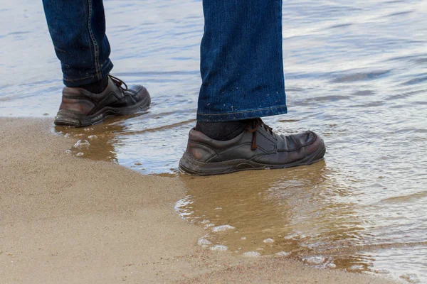 Mans feet standing water. — Stock Photo, Image