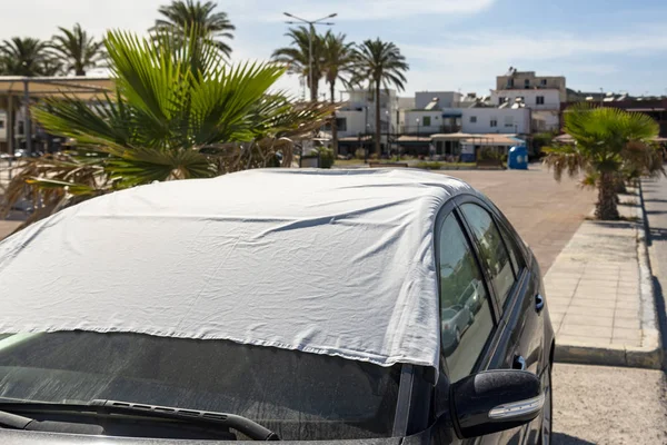 Car covered with white bed sheet. — Stock Photo, Image