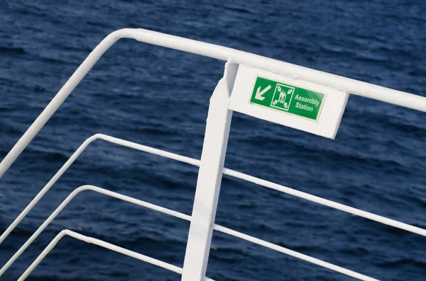 A ferry sign for passengers indicating where to congregate in an emergency — Stock Photo, Image