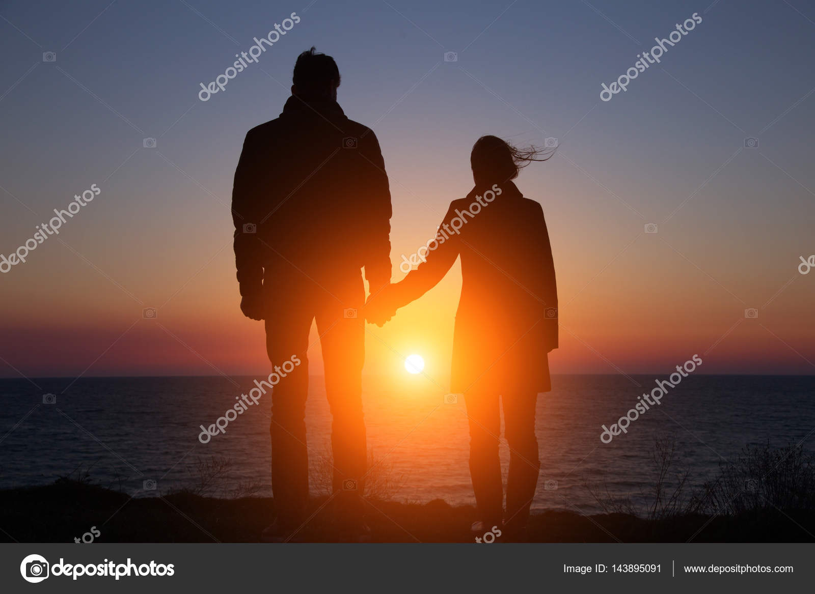 Silhouette Guy And Girl On A Beautiful Sunset Holding Hands Stock Photo Image By C Santiaga