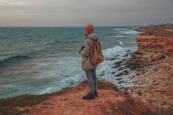 Mann sucht Leuchtturm am Meer — Stockfoto