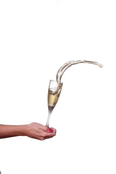Champagne splash od skla ženských rukou, samostatný — Stock fotografie