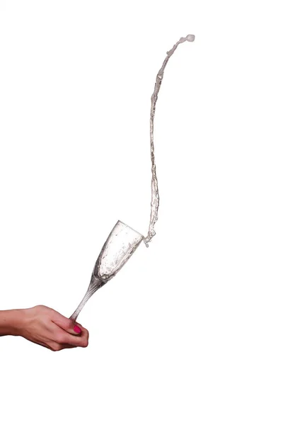 Champagne splash från glas med kvinnlig hand isolerade — Stockfoto