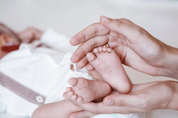 Pasgeboren baby 's voeten op vrouwelijke handen closeup. — Stockfoto