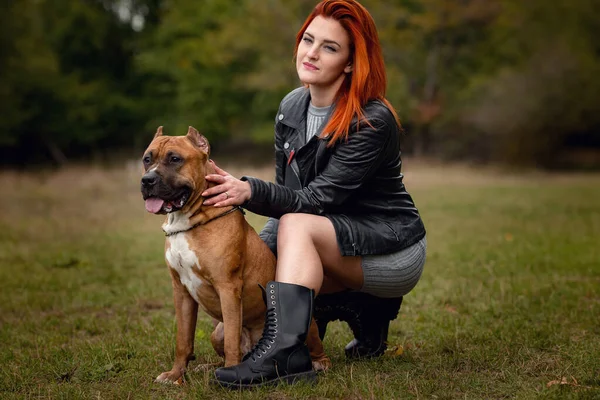 Mooie vrouw en haar hond in het najaar park — Stockfoto