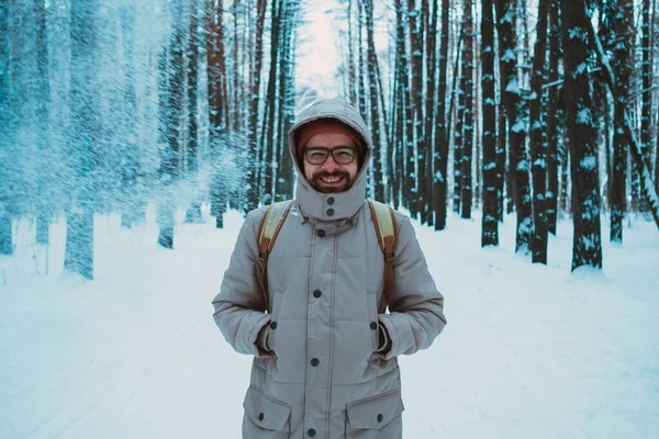 Mladý muž v zimě zasněžený les — Stock fotografie