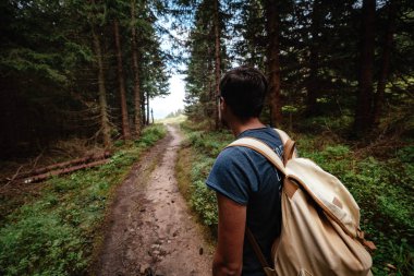 Man hiking at mountains with heavy backpack