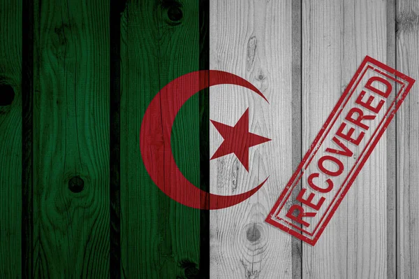 flag of Algeria that survived or recovered from the infections of corona virus epidemic or coronavirus. Grunge flag with stamp Recovered