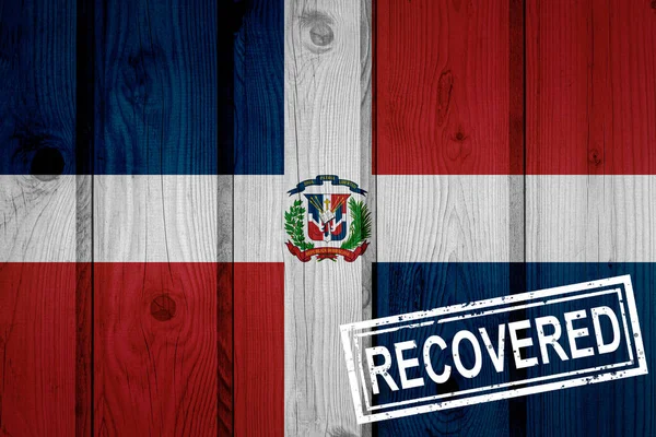 flag of Dominican Republic that survived or recovered from the infections of corona virus epidemic or coronavirus. Grunge flag with stamp Recovered