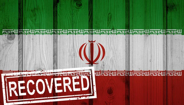 flag of Iran that survived or recovered from the infections of corona virus epidemic or coronavirus. Grunge flag with stamp Recovered