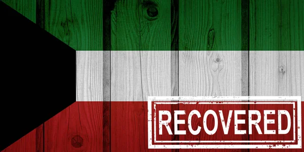 flag of Kuwait that survived or recovered from the infections of corona virus epidemic or coronavirus. Grunge flag with stamp Recovered