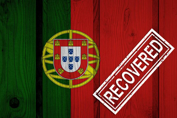 flag of Portugal that survived or recovered from the infections of corona virus epidemic or coronavirus. Grunge flag with stamp Recovered