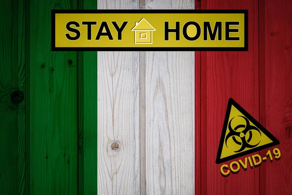 Flag of the Italy in original proportions. Quarantine and isolation - Stay at home. flag with biohazard symbol and inscription COVID-19.
