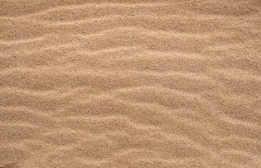 Kumun altın dokusu. Sahildeki kumu arka plan olarak kullan. Güzel çöl
