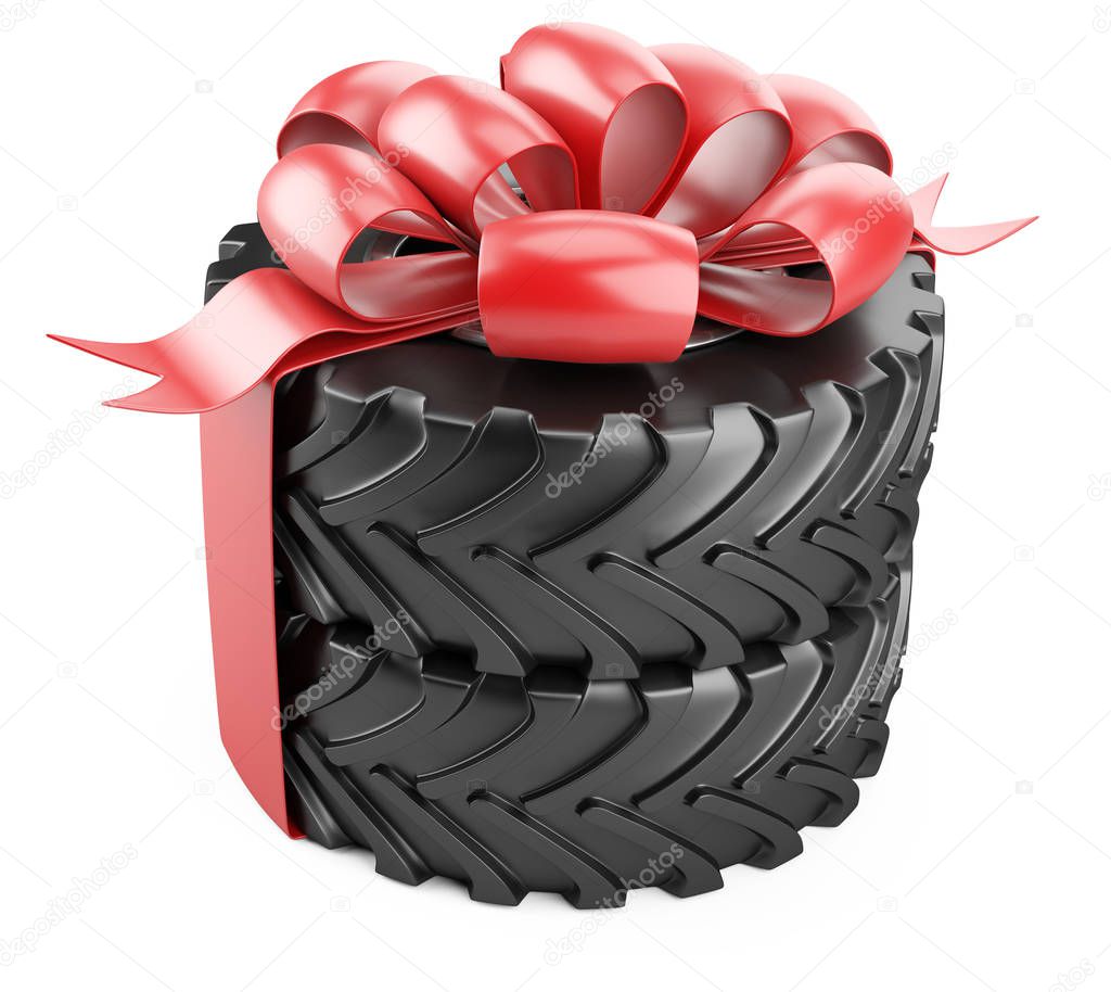 Big tire with red bow and ribbons. Heavy equipment vehicle.