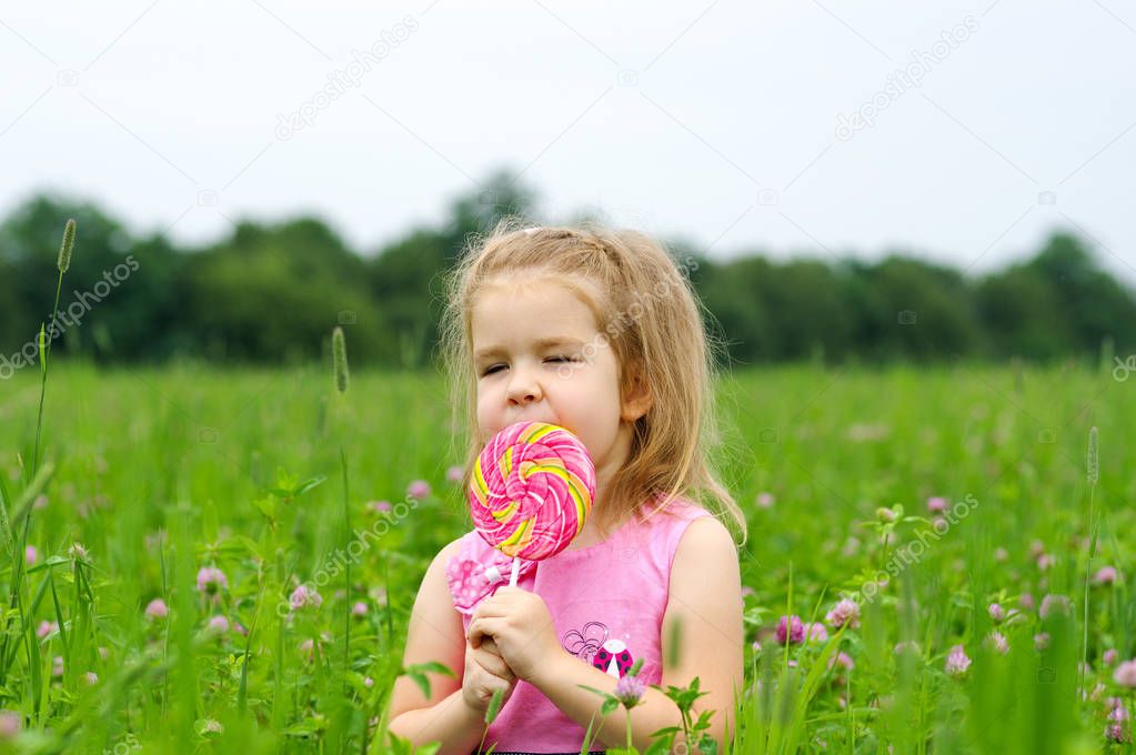  little girl eating a lollipop