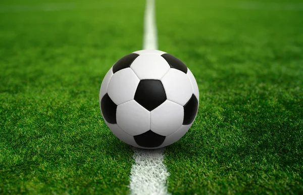 Soccer ball on green football field — Stock Photo, Image