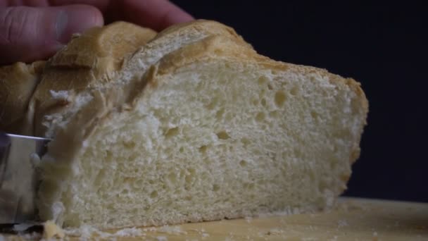 Male hand cutting loaf of bread. — Stock Video
